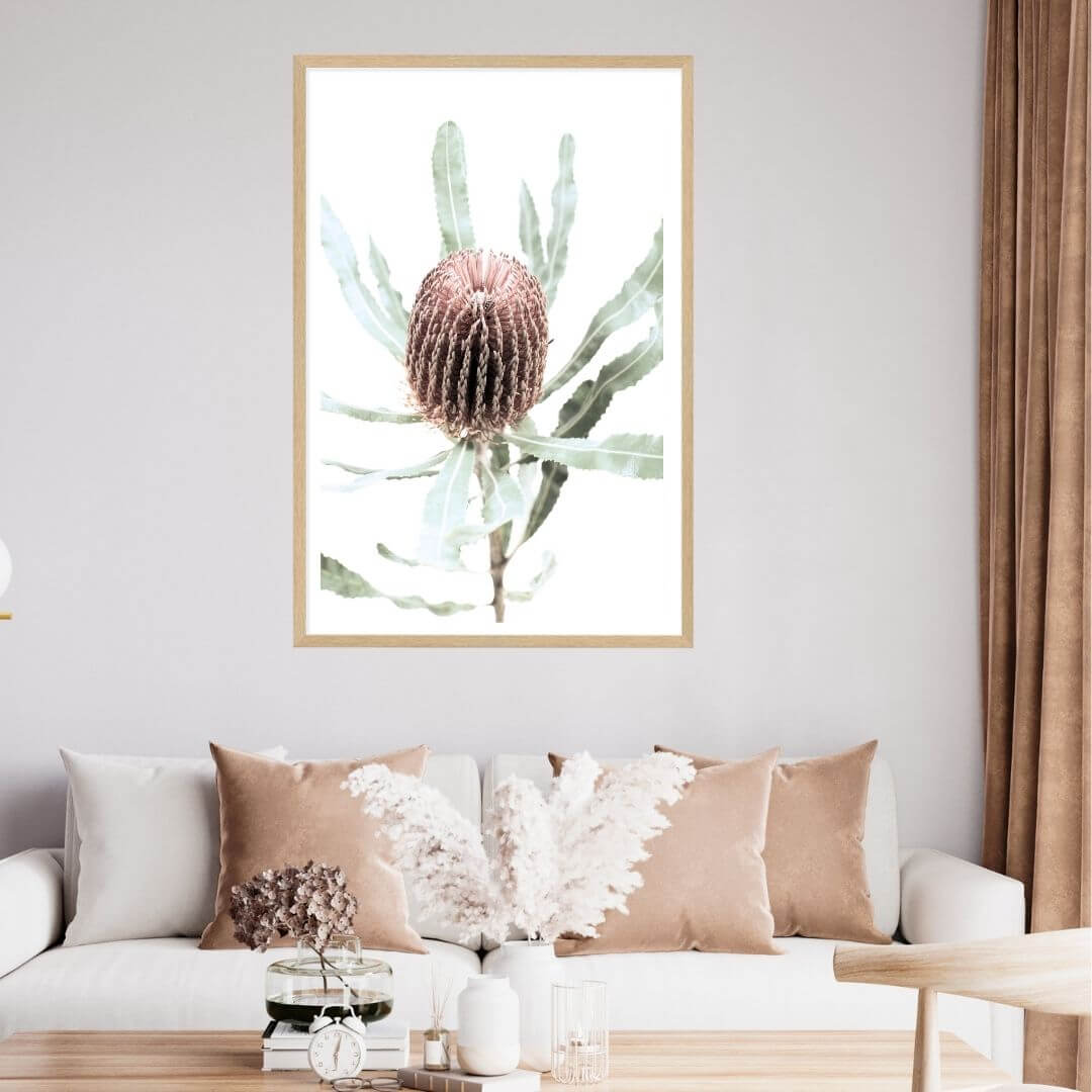 A floral Australian Natives artwork of one Australian native peach Banksia flower B in a timber framed print on a living room wall. 