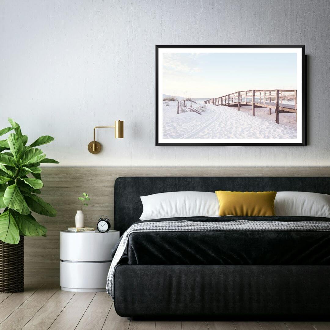 A wall art photo print of a beachside boardwalk with a black frame or unframed to style your bedroom walls