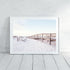 A wall art photo print of a beachside boardwalk with a white frame or unframed to decorate an empty wall