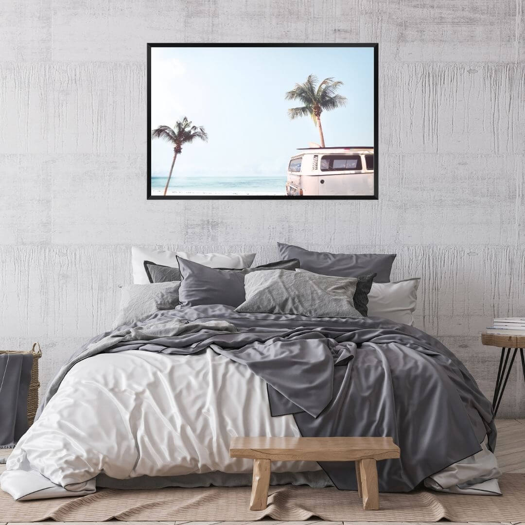 A wall art photo print of a blue beachside kombi van with a frame in black for your bedroom walls
