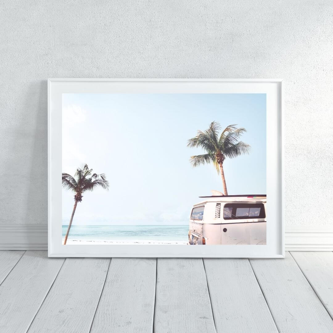 A wall art photo print of a blue beachside kombi van with a white frame or unframed to decorate an empty wall