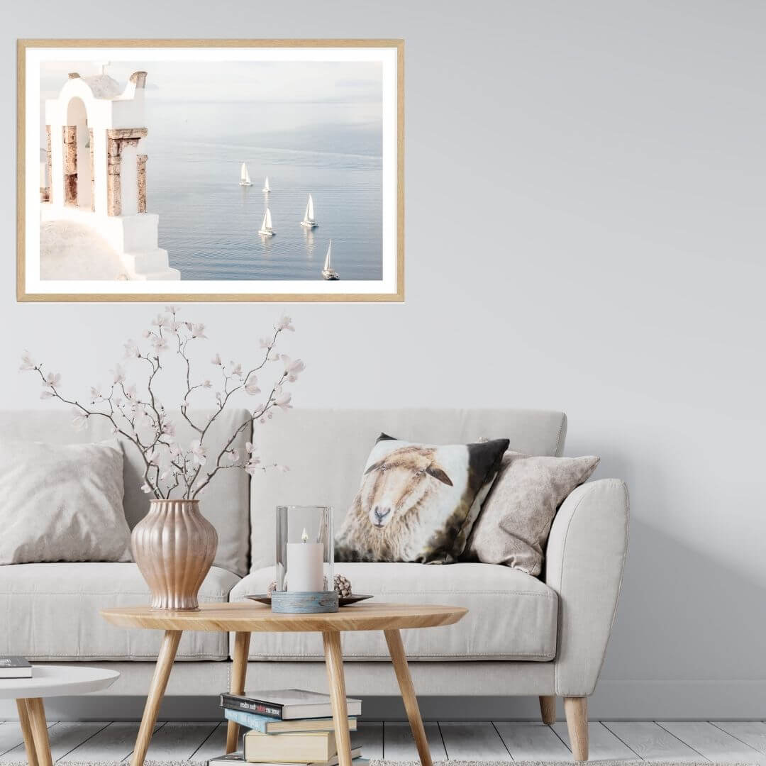 A wall art photo print of Boats sailing on the sea in Santorini Greece  with a timber frame or unframed for your coastal living room behind sofa