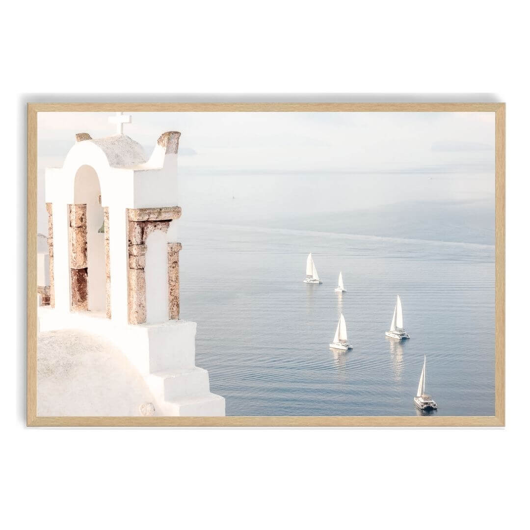 A coastal wall art photo print of Boats sailing on the sea in Santorini Greece  with a timber frame, no white border at Beautiful Home Decor