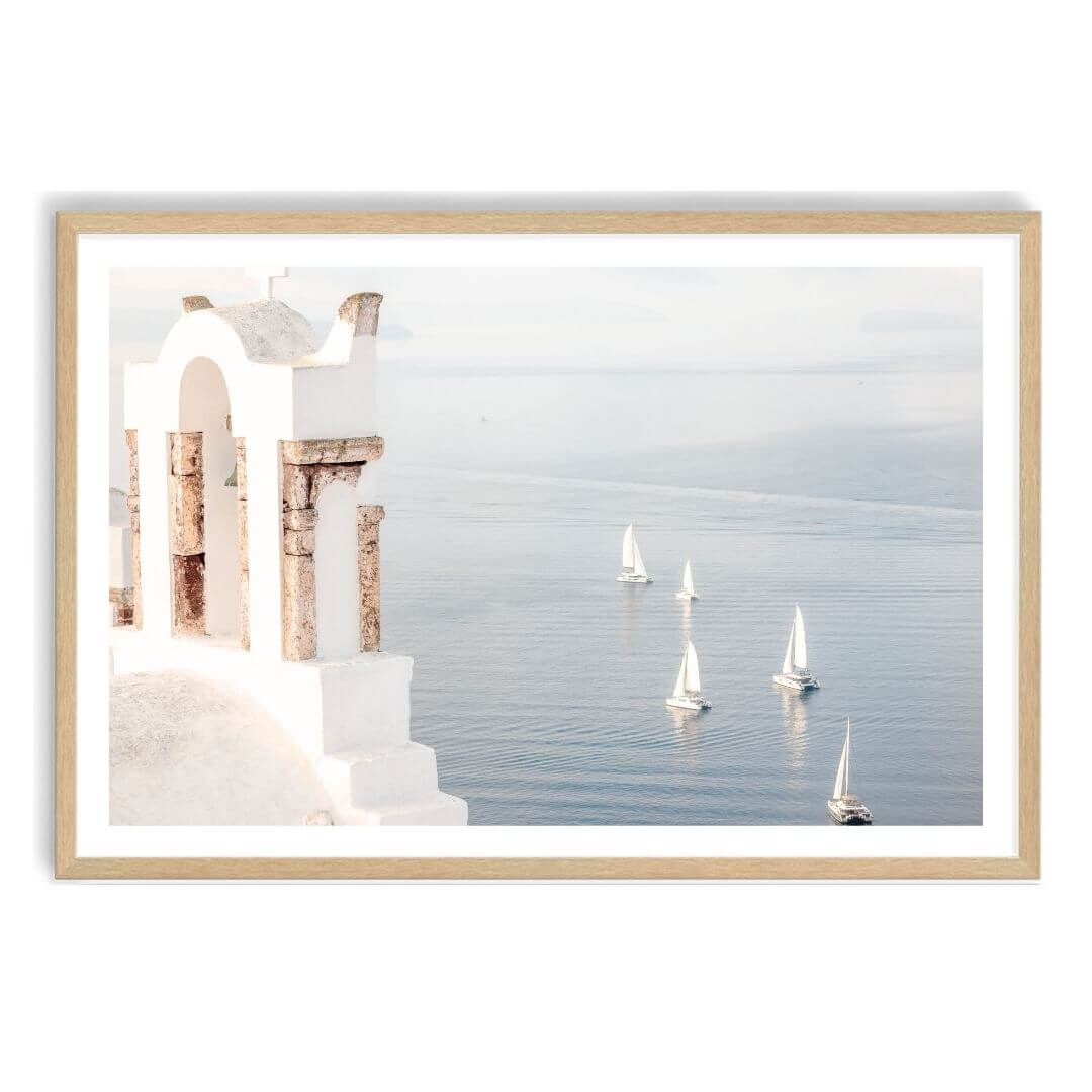 A coastal wall art photo print of Boats sailing on the sea in Santorini Greece  with a timber frame, white border by Beautiful Home Decor