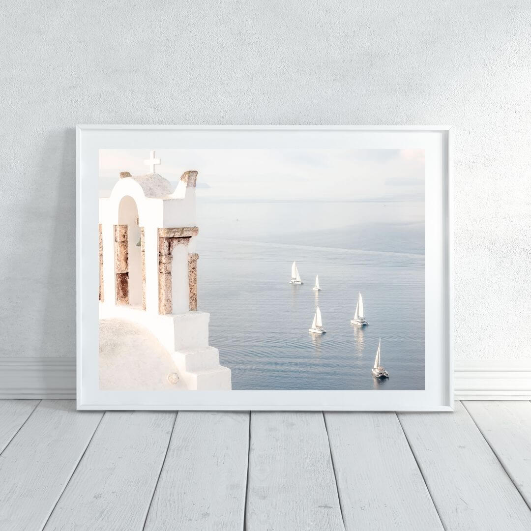 A wall art photo print of Boats sailing on the sea in Santorini Greece  with a white frame or unframed to decorate an empty wall