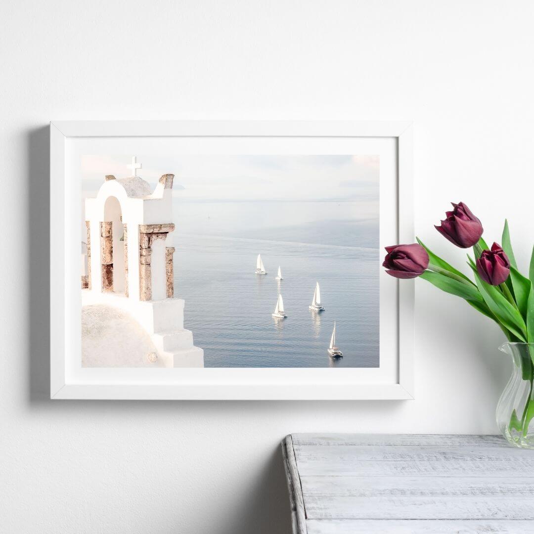 A wall art photo print of Boats sailing on the sea in Santorini Greece  with a white frame or unframed to style shelves and empty walls