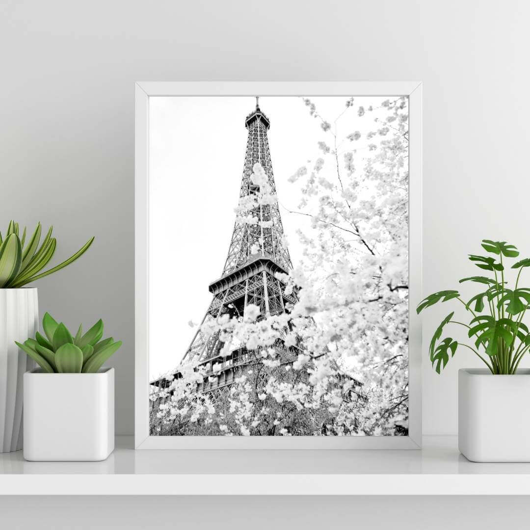 A black and white wall art photo print of the Eiffel Tower in Spring with a white frame or unframed to style shelves and empty walls