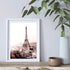 A wall art photo print of the Eiffel Tower in Paris with a white frame or unframed to decorate an empty wall