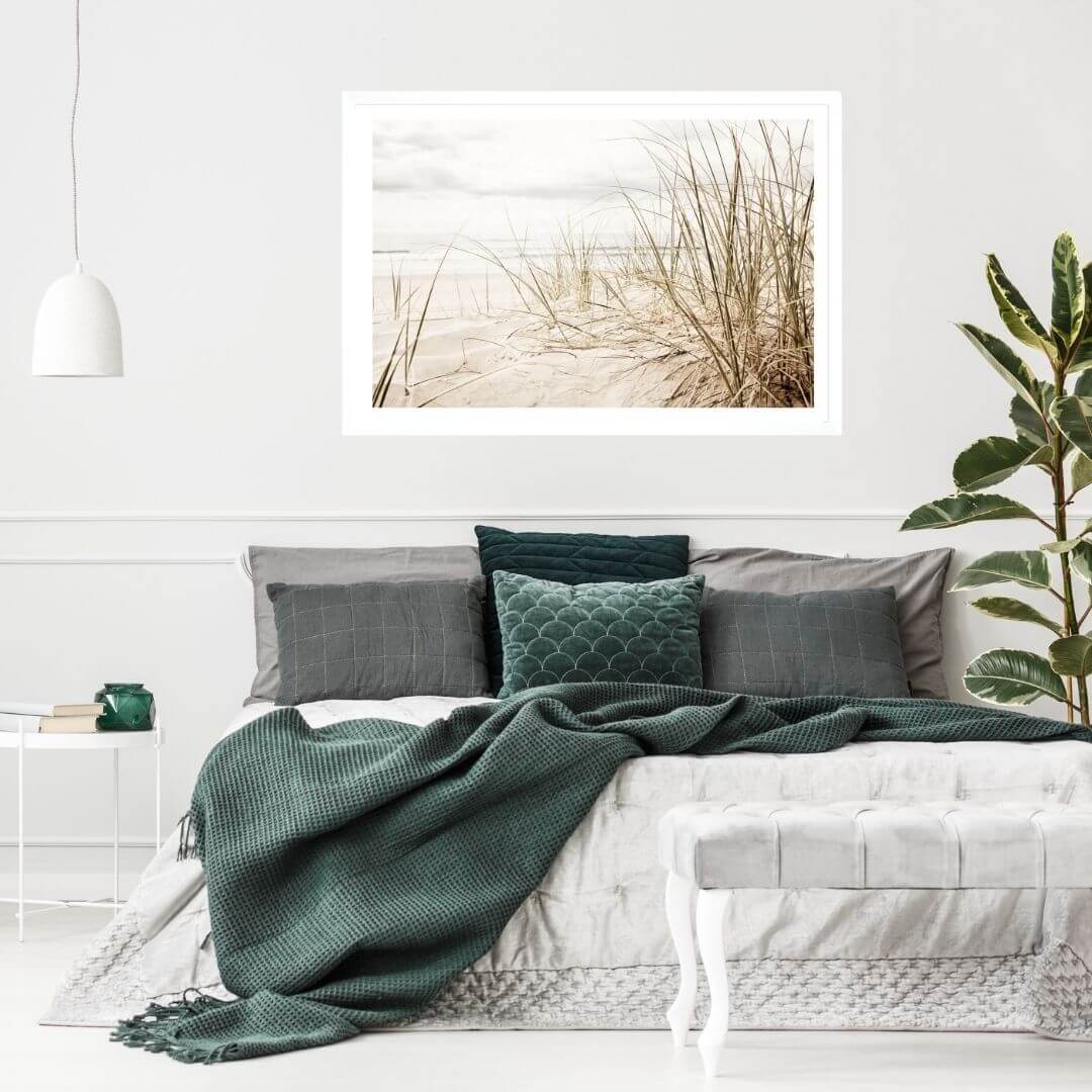 A wall art photo print of a grassy beach shore with a white frame for the bedroom wall with free shipping