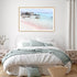 A wall art photo print of a pink beach in Greece with a timber frame to style a coastal Australian bedroom