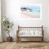 A wall art photo print of a pink beach in Greece with a white frame for the hallway wall with free shipping