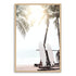 A photo wall art print of two white surf boards under the palm trees on a surfer beach in Hawaii in a timber frame.