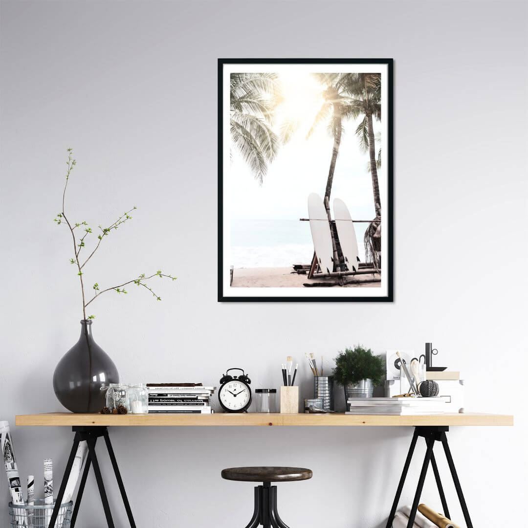 A wall art print in an office wall of two surf boards under the palm trees on a surfer beach in Hawaii