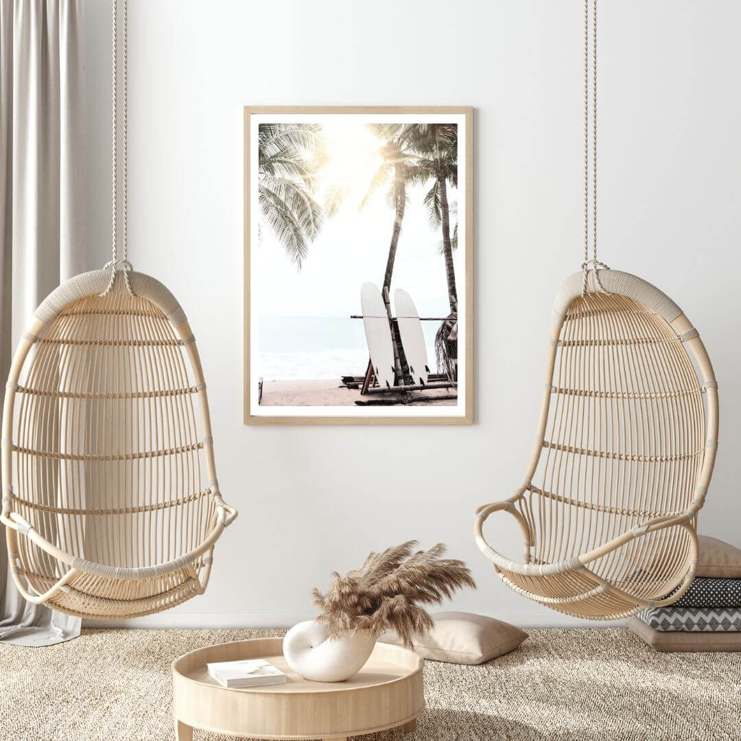 A photo wall art of two white surf boards under the palm trees on a surfer beach in Hawaii