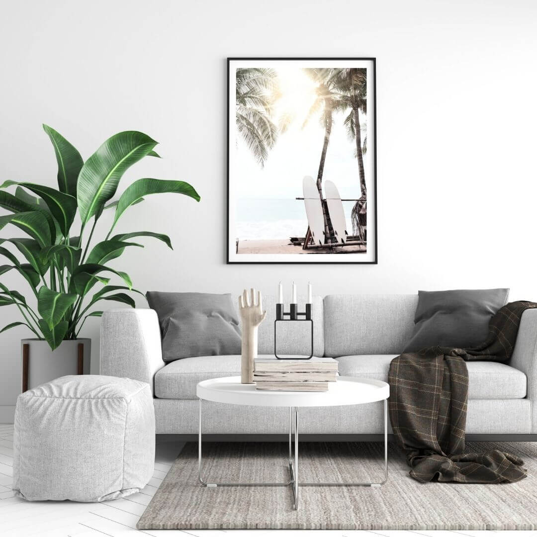 An artwork of two white surf boards under the palm trees on a surfer beach in Hawaii in a wall art print black frame