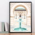 A wall art photo print of a Moroccan Temple water feature with a black frame on shelf by Beautiful HomeDecor