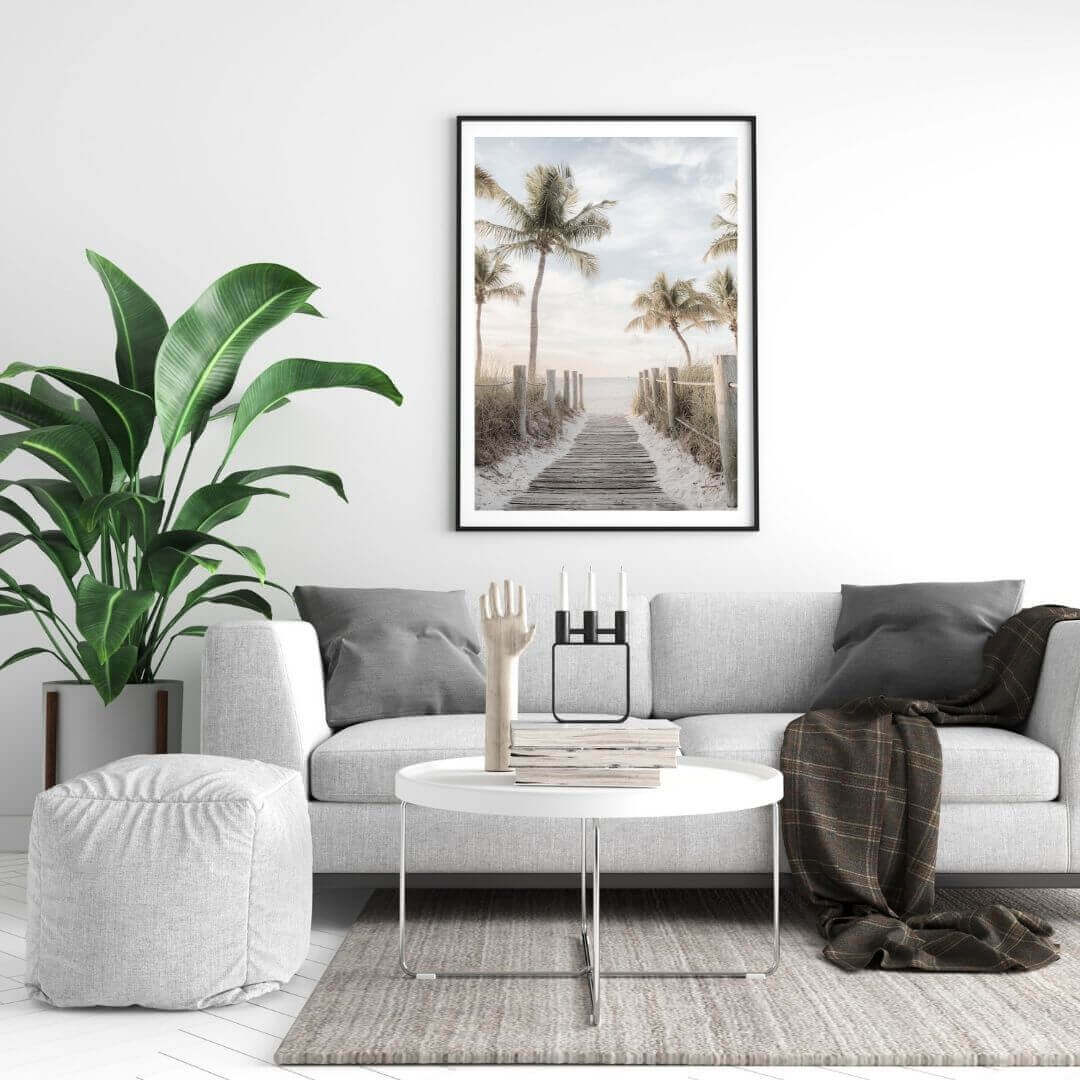 A wall art photo print of a pathway to a beach on the Keys Florida with a black frame on a wall above a sofa by Beautiful HomeDecor