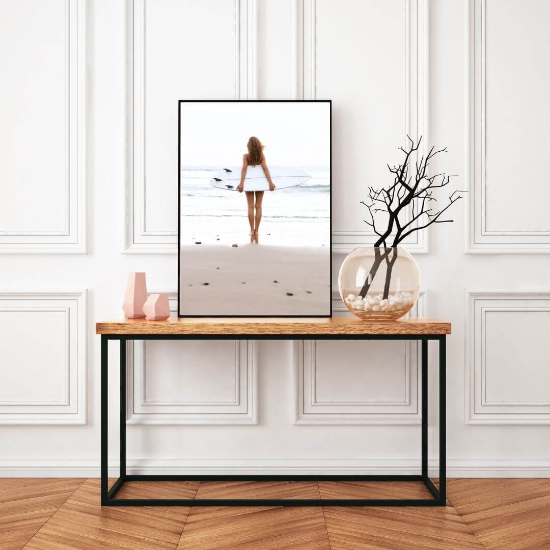 A wall art photo print of the girl with the surfboard with a black frame or unframed to decorate an empty wall