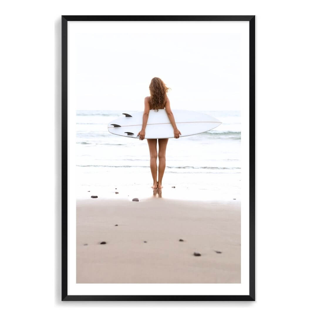 A wall art photo print of the girl with the surfboard with a black frame, white border by Beautiful Home Decor