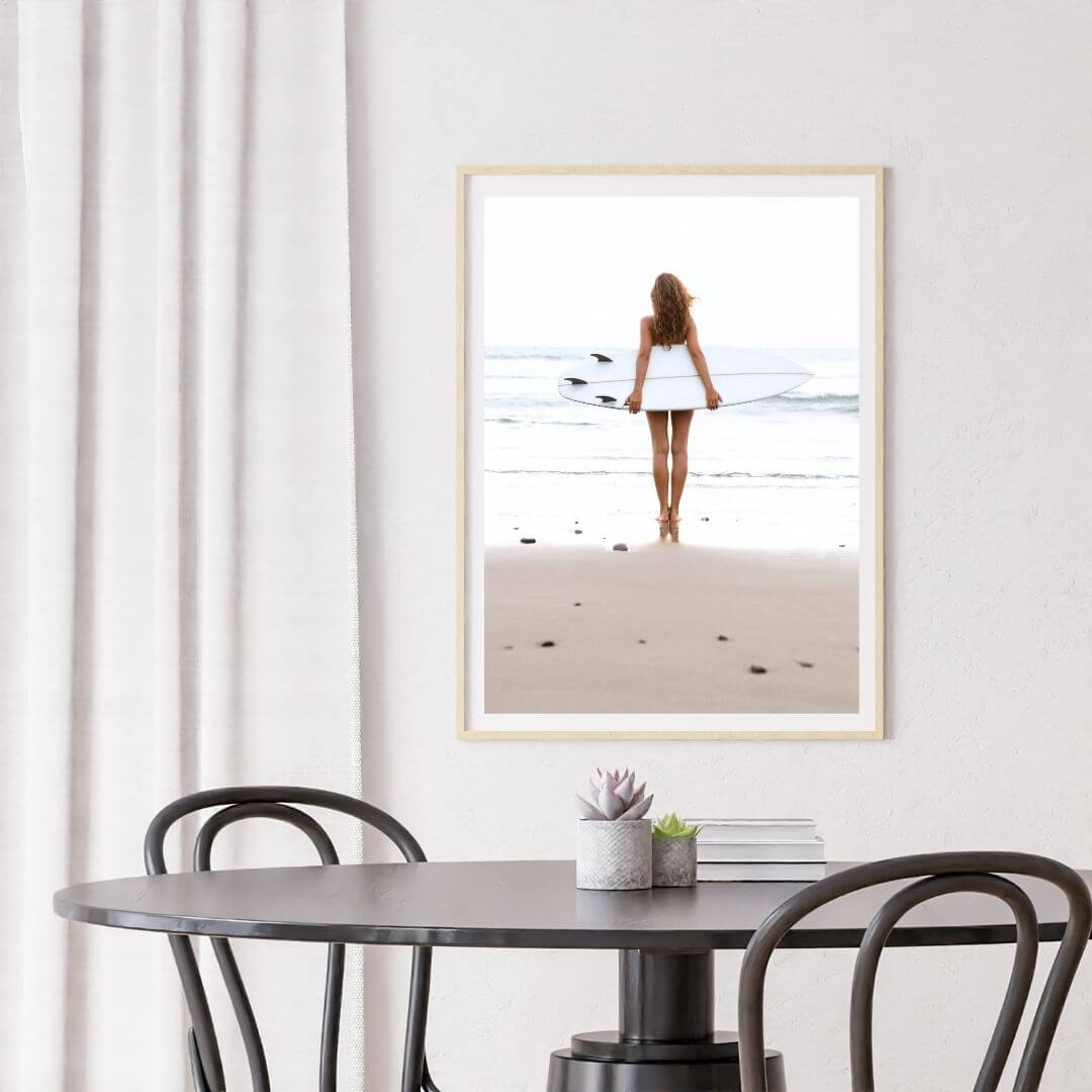 A wall art photo print of the girl with the surfboard with a timber frame or unframed for your dining room empty walls