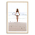 A wall art photo print of the girl with the surfboard with a timber frame, white border by Beautiful Home Decor