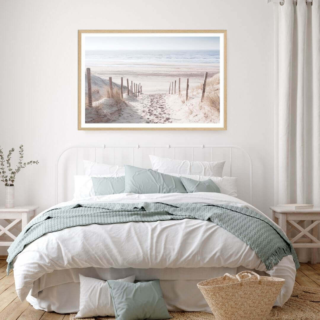 A wall art photo print of a walk on the beach with a timber frame to decorate your bedroom walls