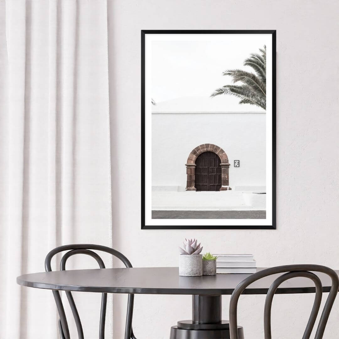 A white Spanish church and door Wall Art Photo Print with a black frame or unframed to decorate a wall in your dining room